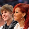 Singers Justin Bieber (C) and Rihanna (R